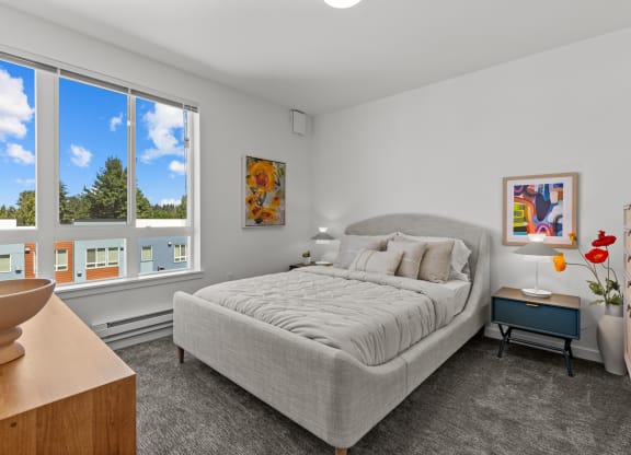 a bedroom with a bed and a large window