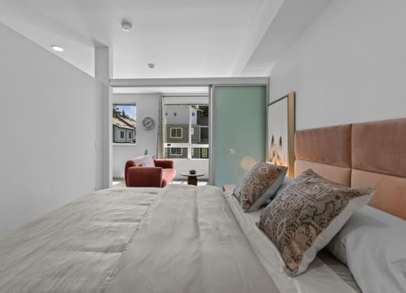 a bedroom with a large bed and a living room with a couch