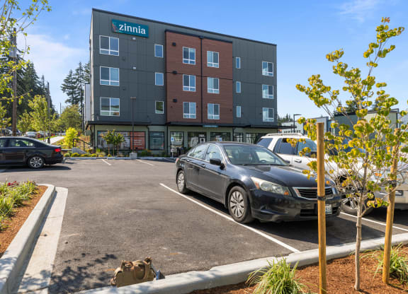 a parking lot with cars in front of a building