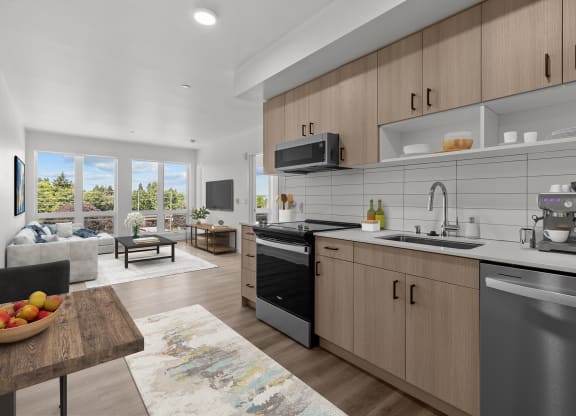 an open kitchen and living room with a large window and a table
