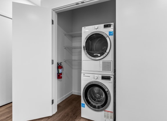a front loading washer and dryer in a laundry room