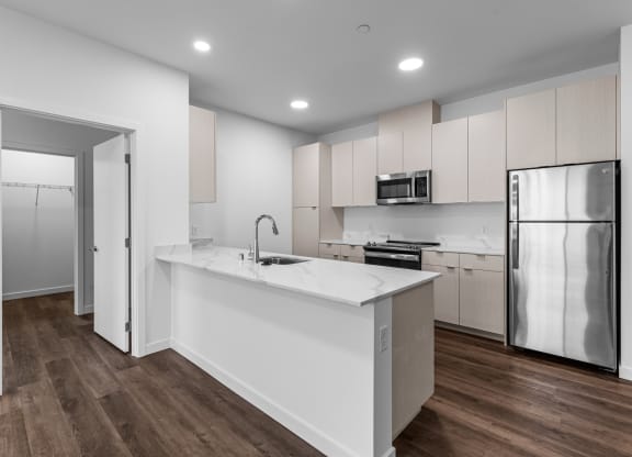 a kitchen with white cabinets and a white counter top