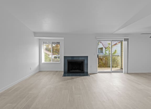 a living room with a fireplace and a sliding glass door