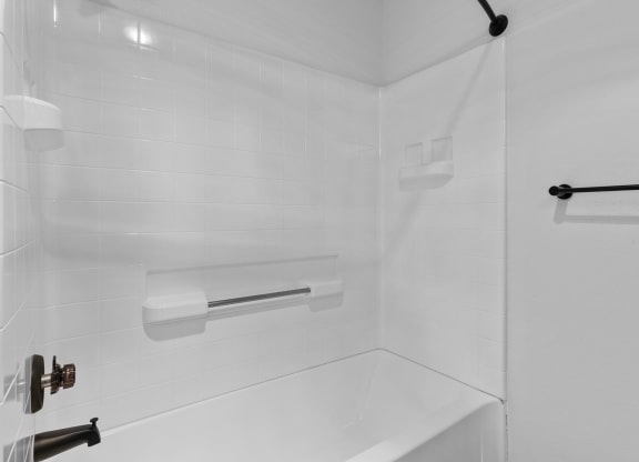 a white bathroom with a shower and a sink