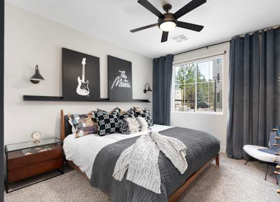 a bedroom with a bed and a ceiling fan