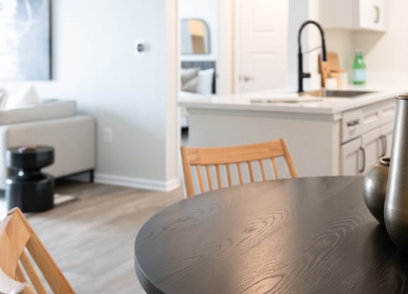 a kitchen with a wooden table and chairs