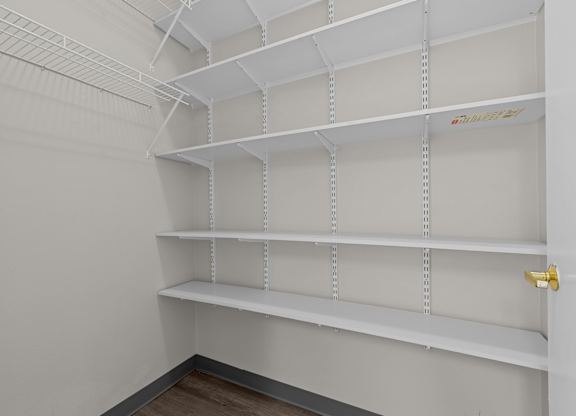 Empty white shelves in a room.