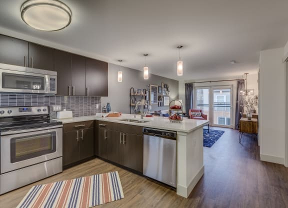 a kitchen with stainless steel appliances and a white counter top