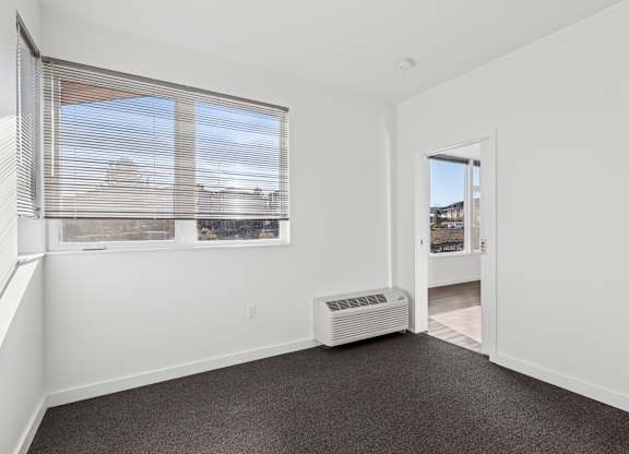 A room with a window and a door.