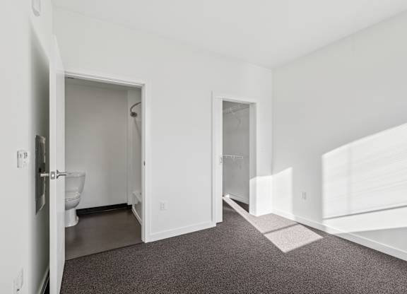 A white bathroom with a toilet and sink.