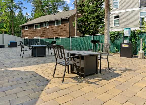 A patio with a table and chairs.