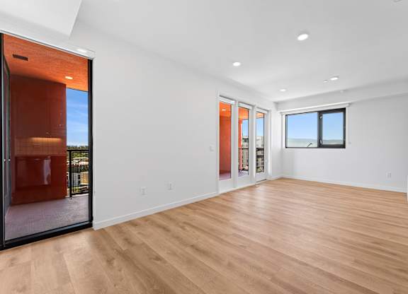 OnyxOnPark_SanDiego_CA_Vacant_2BR_B1_A spacious room with wooden flooring and a large window.