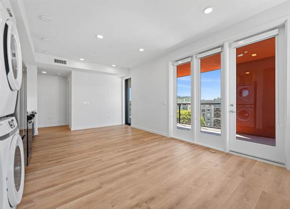 OnyxOnPark_SanDiego_CA_Vacant_2BR_B1_A room with a washing machine and a view of the outside through the window.