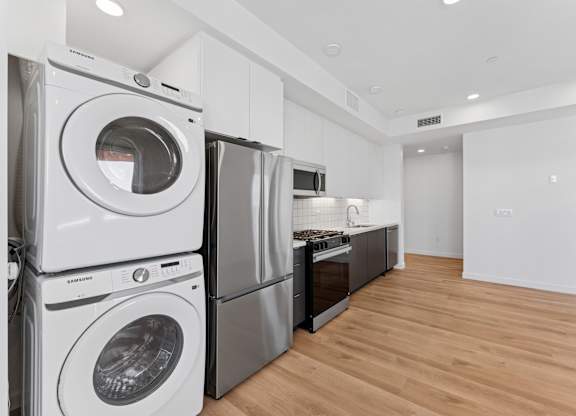 OnyxOnPark_SanDiego_CA_Vacant_2BR_B1_A stack of white washing machines in a laundry room.