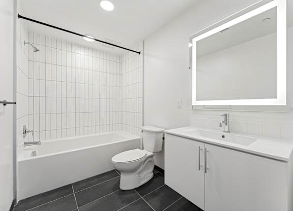 OnyxOnPark_SanDiego_CA_Vacant_2BR_B1_A white bathroom with a toilet, sink, and bathtub.