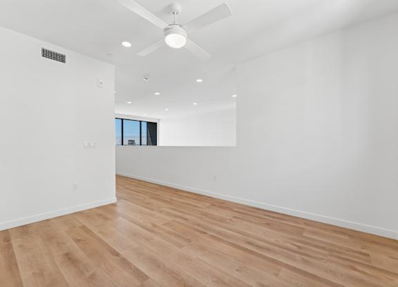 OnyxOnPark_SanDiego_CA_Vacant_Penthouse_A_A room with a ceiling fan and wooden flooring.
