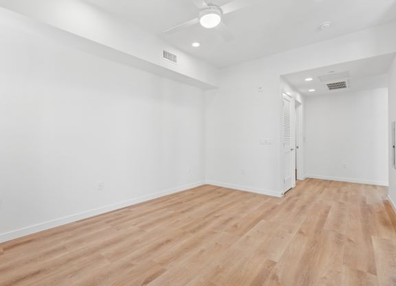 OnyxOnPark_SanDiego_CA_Vacant_Penthouse_A_A room with wooden flooring and white walls.