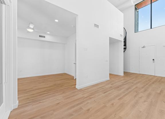 OnyxOnPark_SanDiego_CA_Vacant_Penthouse_A_OnyxOnPark_SanDiego_CA_Vacant_Penthouse_A_A room with wooden floors and white walls.