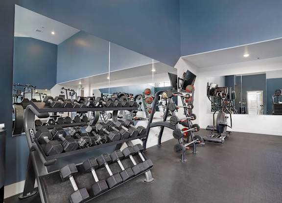 Alvera at the Meadows  gym with a variety of equipment including treadmills, weights, and exercise machines.
