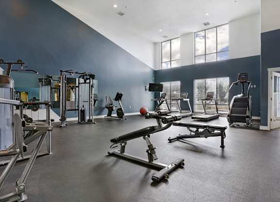 Alvera at the Meadows  gym with a variety of equipment including weights and weight machines.