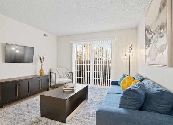 a living room with a blue couch and a tv