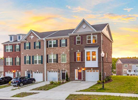 A large brick house with a white garage door in front.