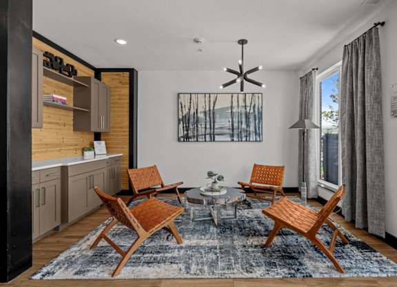 A modern living room with a wooden chair set and a rug.