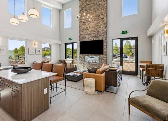 A modern living room with a stone fireplace and a flat screen TV.