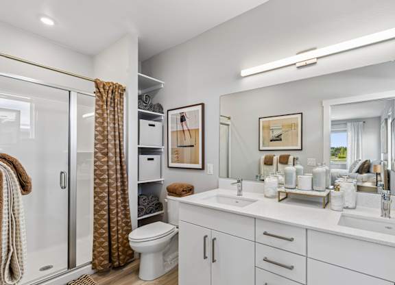 A bathroom with a white toilet, sink, and mirror.