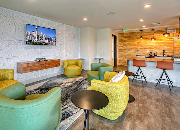 a living room with chairs and a bar and a television