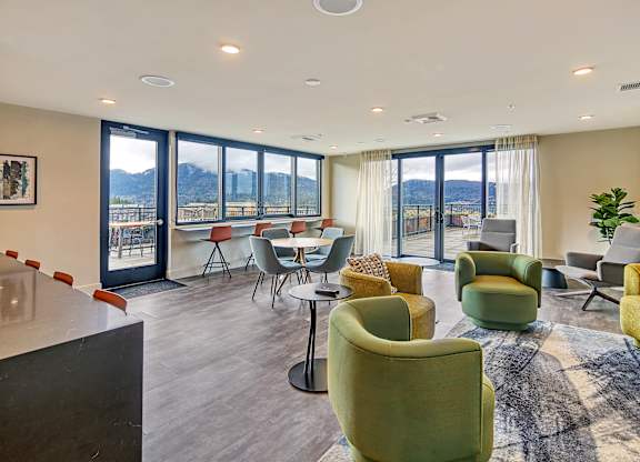 a living room with couches and chairs and a table with chairs