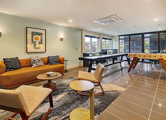 a living and dining room with a table and chairs