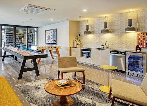 a kitchen and living room with a table and chairs