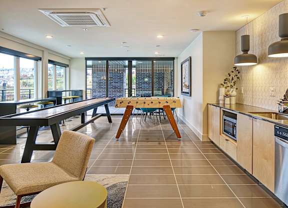 a kitchen and dining room with a table and chairs and a sink