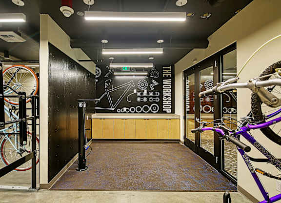 a room with bikes and a black wall with a chalkboard on it