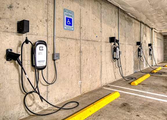 a row of charging stations on the wall of a parking garage