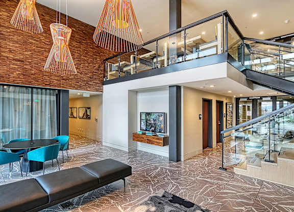 the lobby of a building with a staircase and a tv