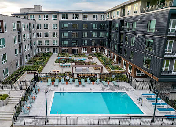 an aerial view of an apartment building with a swimming pool