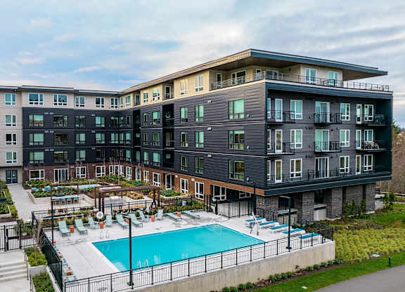 a large building with a swimming pool in front of it