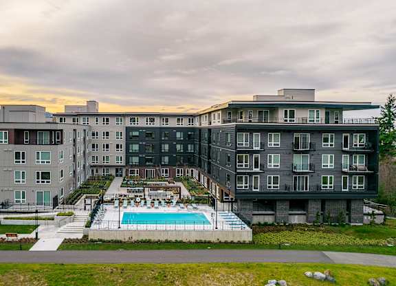 an aerial view of a building with a swimming pool