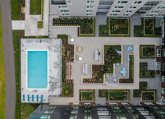 a birds eye view of a building with a pool and plants