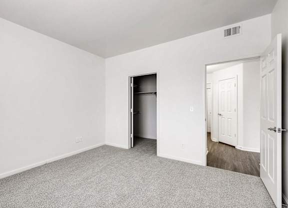 A room with a white door and a white wall.