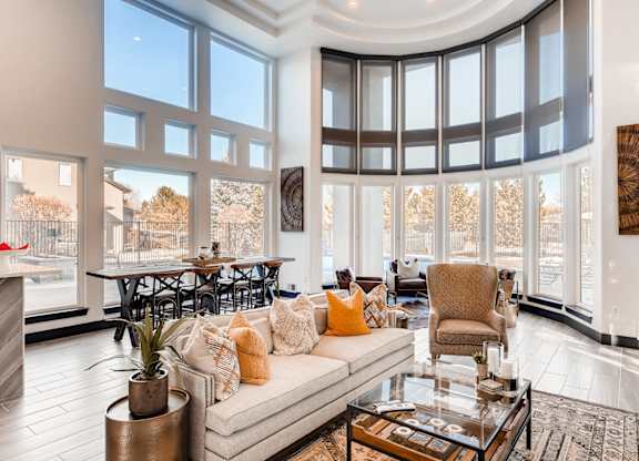 A living room with a large couch and a fireplace.