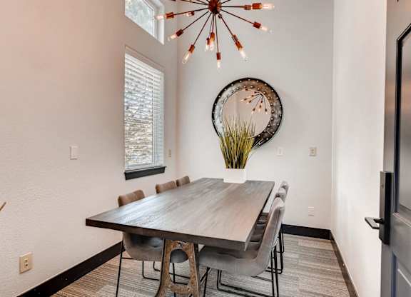 A dining room with a wooden table and chairs.