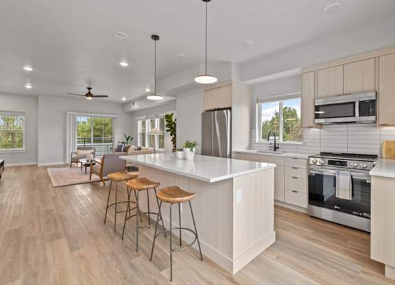 A modern kitchen with a bar area and a dining table.