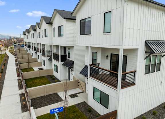 Apartment complex with white buildings and balconies.