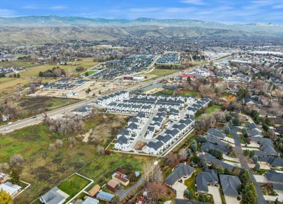 A bird's eye view of a residential area with houses and a large building in the center.