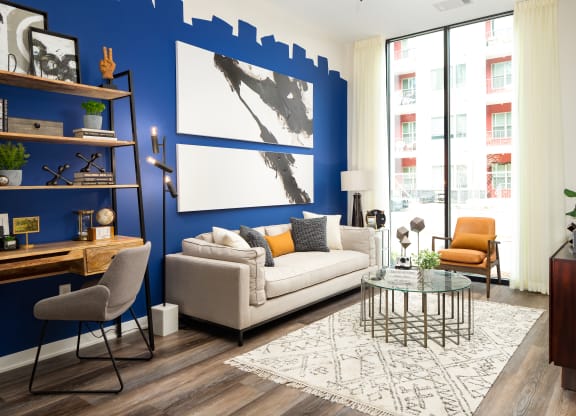 a living room with a blue accent wall