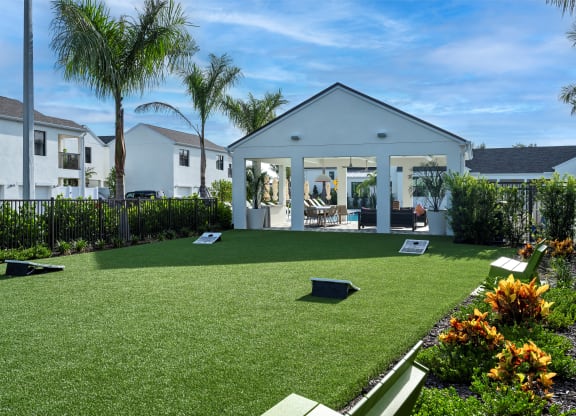 Altair by Soltura a backyard with artificial turf and a house with a patio