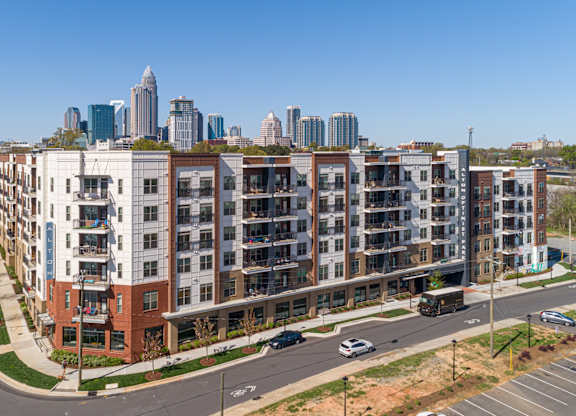 A view of a city with apartment buildings in the foreground.